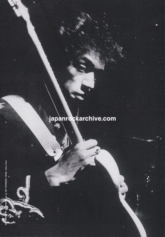 Jimi Hendrix playing guitar, black and white Japanese music press pinup, July 1997