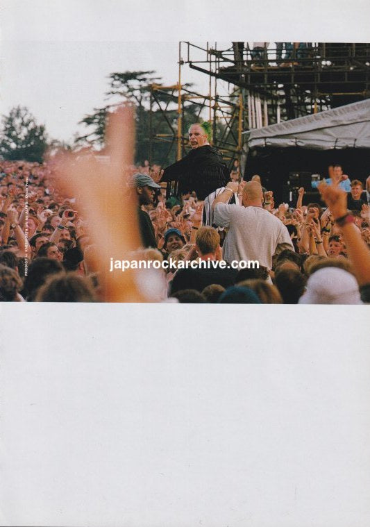 The Prodigy December 1996 Japanese magazine pinup with a color live concert photograph showing a performer among the crowd
