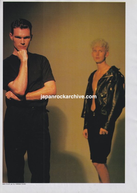 Red Flag November 1989 Japanese magazine color pinup showing the duo posed against a warm-toned background