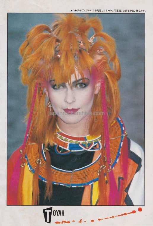 Japanese music press clipping featuring a color photo of Toyah Wilcox with orange hair and a variety of decorative necklaces.